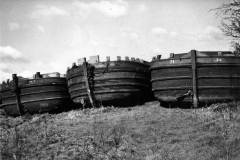 Three barges on dry land.