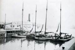 Four moored sloops.