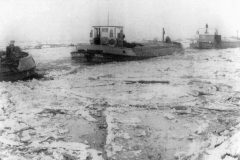 Two barges on an iced up canal.