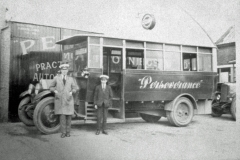 A bus driver and conductor by their coach.