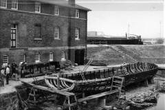 Repairing a wooden barge.