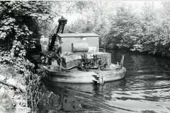 A crane equipped dredger.