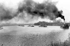 A steam tug with keels under tow.