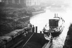 The President towing a dumb barge out of New Dock.