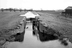A derelict lock on a section of raised canal.