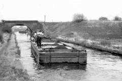A tug towing two compartment boats.