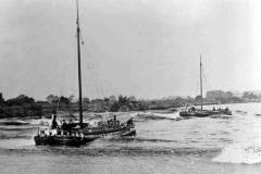 Two sailing keels running in rough water.
