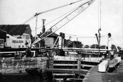 Installing replacement canal lock gates.