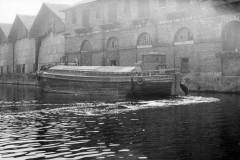 Barge Annie H moored at a warehouse.
