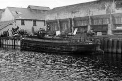 A barge moored alongside a wharf.