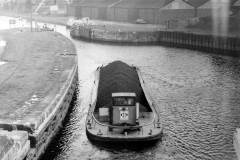 Motor barge No 5 is seen passing through Castleford Flood Lock No 9.