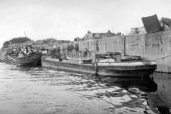 Alongside a concrete river wharf.