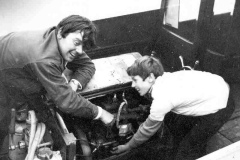 Peter L Smith adjusting an engine.