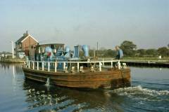 A British Waterways diesel tug approaching a lock.