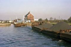 A British Waterways diesel tug approaching a lock.