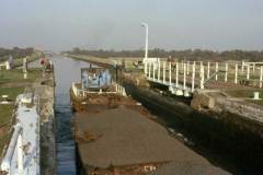 A British Waterways diesel tug leaving a lock.