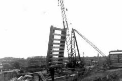 A crane lifting a canal lock gate.