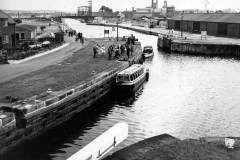 Officials and guests are about to board passenger boats.