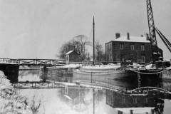 A sloop moored alongside a wharf.