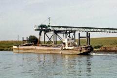 Loading a barge via a conveyor.