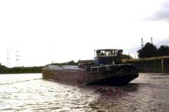 An unladen motor barge under way.