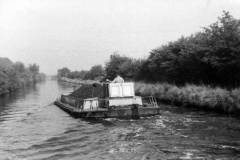 A coal laden motor barge under way.