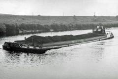 A coal laden motor barge.