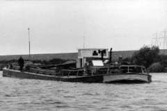 A fully laden motor barge under way.