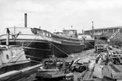Two berthed, very smart motor barges.