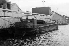 A motor barge alongside a motor vessel.