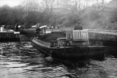 A motor barge approaching a lock.