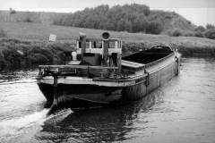 An unladen motor barge.