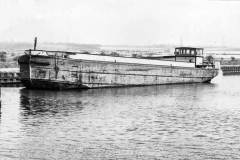 An unladen motor barge.