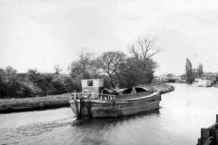 An unladen motor barge underway.