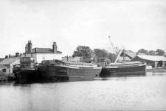 Three berthed motor barges.