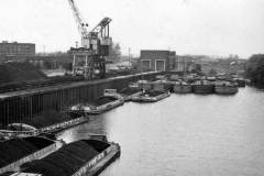 Barges alongside a coal handling facility.