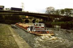 A motor barge leaving Ferrybridge Flood Lock No 11.
