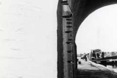 A metal pillar protecting a canal bridge.