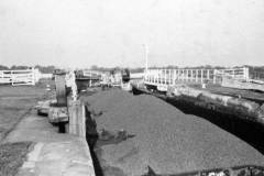 An train of compartment boats in a lock.