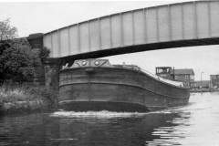 The motor barge Irene passing under a bridge.