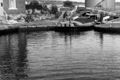 A coal laden motor barge leaving a lock.