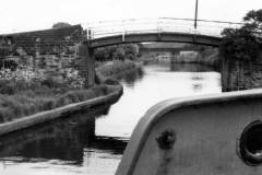 A barge approaching two bridges.
