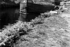 A motor barge has travelled down through a lock.