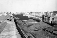 A portion of a train of nineteen coal laden compartment boats.