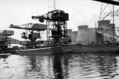 A motor barge alongside a coal unloading facility.