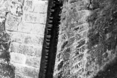 A metal pillar protecting a canal bridge.