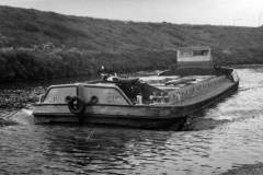 A laden barge under way.