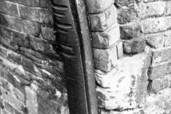 A metal pillar protecting a canal bridge.