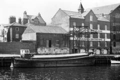 A motor barge berthed on the River Ouse.
