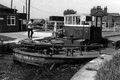 A motor barge passing through Ramsdens Swing Bridge.
